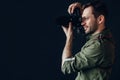 Side view photo of a handsome man taking photo with digital camera. Royalty Free Stock Photo