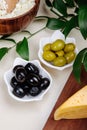 side view of pickled olives with various kind of cheese on white background Royalty Free Stock Photo