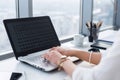 Side view picture of female hands typing, using pc in a light office. Designer working at workplace, searching new ideas Royalty Free Stock Photo