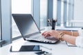 Side view picture of female hands typing, using pc in a light office. Designer working at workplace, searching new ideas Royalty Free Stock Photo