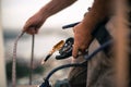 Industrial rope access worker working at height abseiler hand grasping holding Nylon low stretch rope and connecting to descender Royalty Free Stock Photo