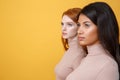 Side view picture of serious young two ladies Royalty Free Stock Photo