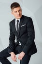 Young business man in modern suit sitting on chair Royalty Free Stock Photo