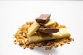 Side view on pile of granola/ muesli spilled among white. brown chocolate bars  on white background. Balanced and healthy Royalty Free Stock Photo