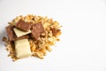 Side view on pile of granola/ muesli spilled among white. brown chocolate bars  on white background. Balanced and healthy Royalty Free Stock Photo