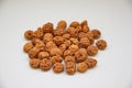 Side view of a pile of insulated tigernuts on a white background. The Spanish tigernut is called chufa