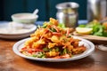 side view of plate piled with mixed veg pakoras