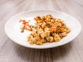 Side view of plate with Turkish Manti with red pepper, tomato sauce, yogurt and mint