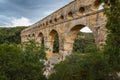 Side view of the Pont du Gard, an ancient Roman aqueduct bridge through Gardon River in Provence, southern France. Royalty Free Stock Photo