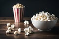 Side view of popcorns in white bowl isolated on dark background.