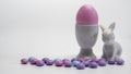 Side view of Porcelain Egg Cups with pink Easter egg on a white background Royalty Free Stock Photo