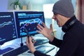 Side view portrait of angry aggressive young hipster man sitting at table holding his mobile phone while working with financial Royalty Free Stock Photo