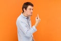 Angry rude man standing looking away with aggression, showing middle finger, fighting with someone. Royalty Free Stock Photo