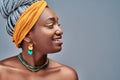 Side view portrait of beautiful attractive African American woman over grey studio background Royalty Free Stock Photo