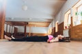 Side view portrait of beautiful young woman working out, resting after doing yoga exercises, lying in Savasana, Corpse Royalty Free Stock Photo
