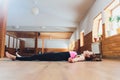 Side view portrait of beautiful young woman working out, resting after doing yoga exercises, lying in Savasana, Corpse Royalty Free Stock Photo