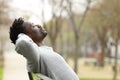 Black man relaxing on a bench in a park Royalty Free Stock Photo