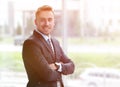 Portrait of confident businessman looking out the window of the office. Royalty Free Stock Photo