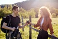 Side view portrait of couple in countryside, man giving cup of tea to girlfriend Royalty Free Stock Photo