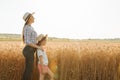 side view, portrait family of farmers mother with daughter in hats in wheat golden field