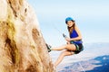 Female climber using abseil method of roping down