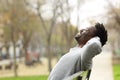 Happy black man relaxing on a bench in a park Royalty Free Stock Photo