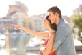Couple pointing away in the street Royalty Free Stock Photo
