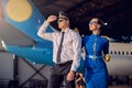 Handsome man and woman having fun in the aviation hangar Royalty Free Stock Photo