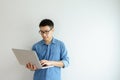 Side view Portrait of happy young businessman holding in hands laptop working at office. looking at laptop computer screen Royalty Free Stock Photo