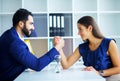 Side view portrait of man and woman armwrestling, exerting press