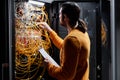 Network technician working with servers and connecting cables Royalty Free Stock Photo