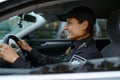 Side view portrait police woman driving car