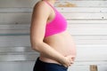 Side view portrait of a pregnant woman holding stomach Royalty Free Stock Photo