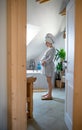 Portrait of pregnant woman indoors at home, standing on scales. Royalty Free Stock Photo