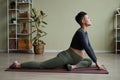 Pregnant young woman doing yoga at home stretching Royalty Free Stock Photo