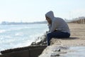 Sad teenager girl alone on the beach