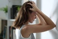 Sad woman complaining leaning on a wall at home