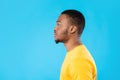 Side-View Portrait Of Serious African American Man Over Blue Background Royalty Free Stock Photo