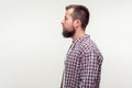 Side view portrait of serious bearded young man looking with calm confident expression. isolated on white background Royalty Free Stock Photo