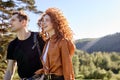 Side view portrait of smiling happy redhead woman and man hikers travelling