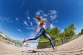 Sportswoman running and sprinting at racetrack