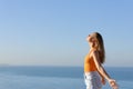 Teen breathing fresh air on the beach with horizon