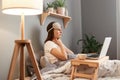 Side view portrait of unhealthy sick ill woman in blindfold, touching her neck, suffering sore throat, sitting in bed in front