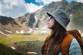 Side view portrait of a woman standing and breathing fresh air in the mountains. Profile of a female explorer breathing