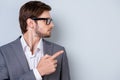 Side view portrait of young businessman in glasses and formalwear pointing on copyspace Royalty Free Stock Photo