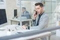 Young Businessman Speaking by Phone at Work Royalty Free Stock Photo