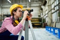 Female geodesist working on site