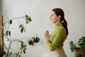 Side view portrait of young woman practicing yoga mindfulness technique