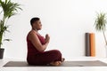 Side view of positive chubby black woman having yoga practice