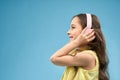 Side view of positive girl in headphones enjoying music Royalty Free Stock Photo